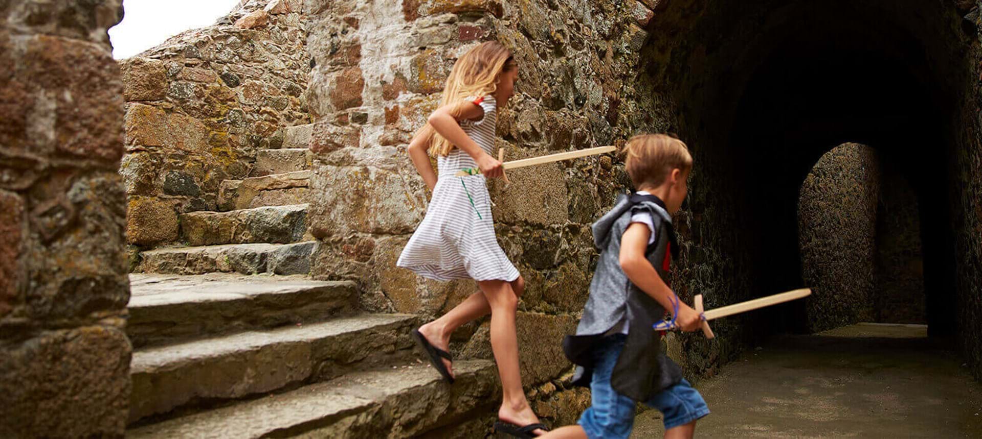 two children playing at castle cornet in guernsey