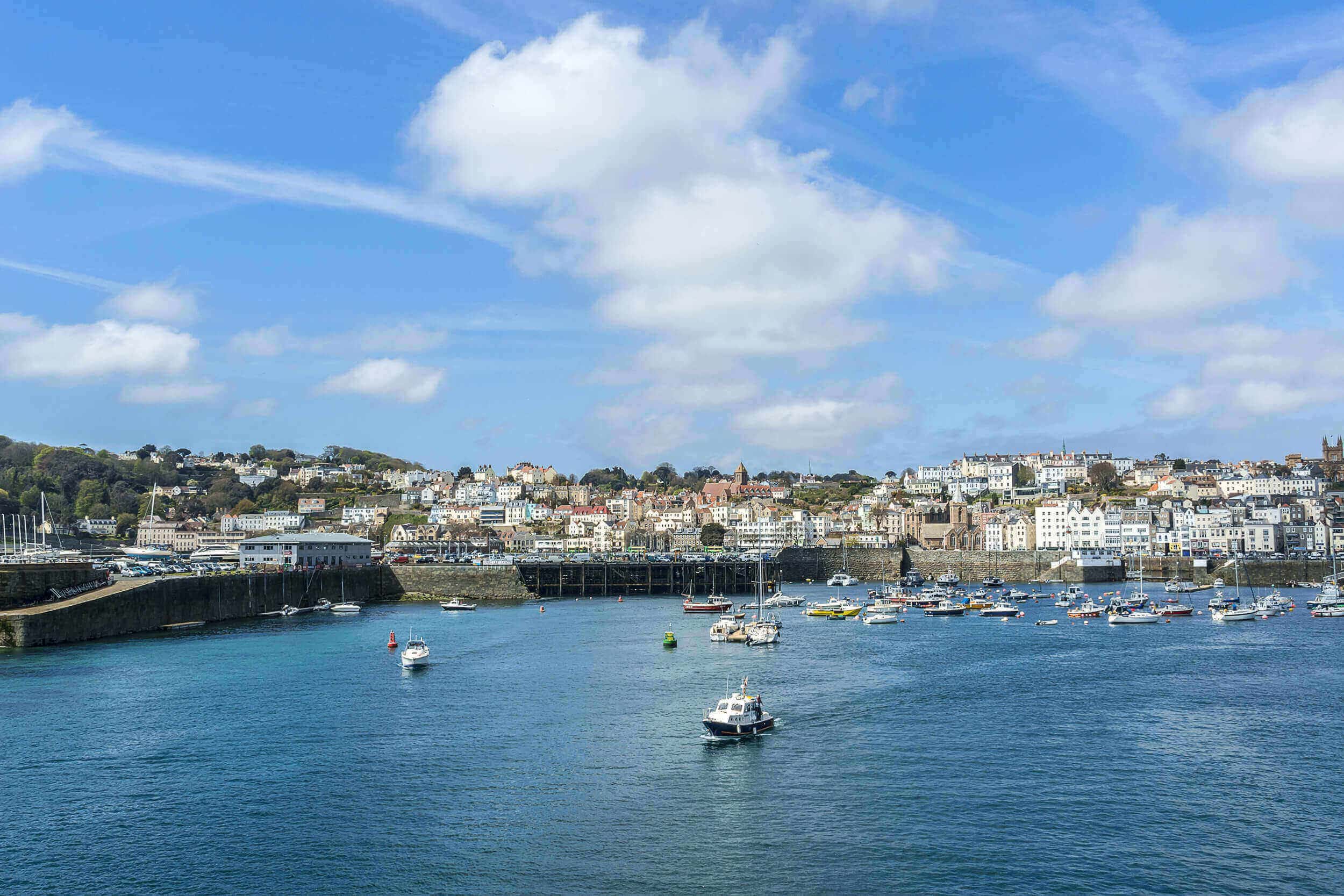 blue sea and sky in boats in harbour at st peter port