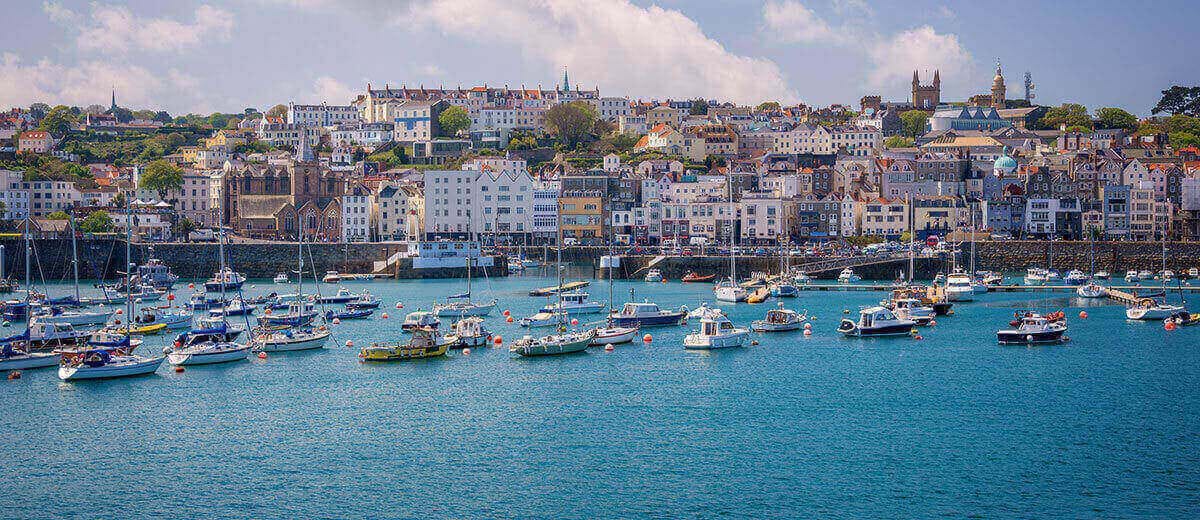 boats in the sea outside st peter port guernsey